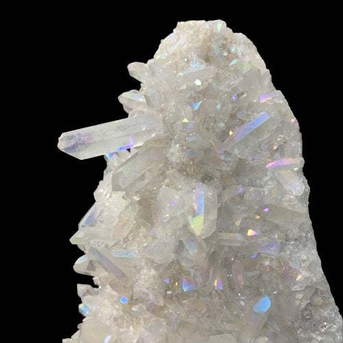 Kindred Crystal Collective — Angel Aura Quartz Cluster, close-up of rainbow iridescent quartz points on black background