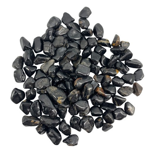 Kindred Crystal Collective — Black Onyx Tumbled 1–2cm, large pile of small polished deep black onyx stones with high-gloss finish and subtle banding on white background