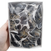 Kindred Crystal Collective — Black Tourmaline Rough Boxed, deep white gift box of chunky raw black tourmaline rough pieces wrapped in plastic, size reference held in hand