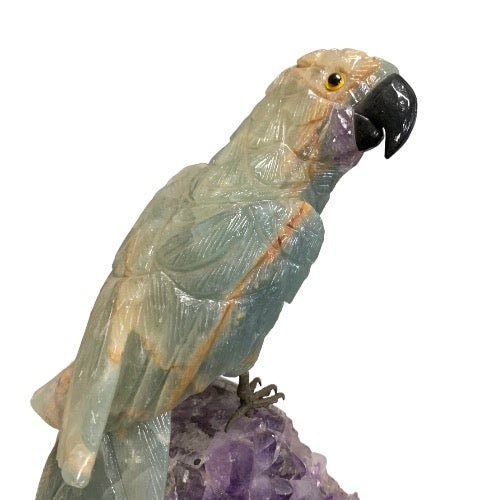 Kindred Crystal Collective — Blue Onyx Parrot on Amethyst Cluster, close-up of carved blue onyx parrot head and beak detail
