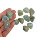 Kindred Crystal Collective — Blue Onyx Tumbled 2–3cm, hand holding three polished seafoam green-blue chalcedony stones with waxy translucent finish and subtle banding