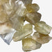 Kindred Crystal Collective — Citrine Rough 1KG Light, pale golden raw citrine chunks spilling from a clear bag on white background.

