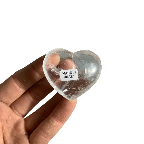 Kindred Crystal Collective — Clear Quartz Heart Brazil, small polished transparent clear quartz heart with natural inclusions, size reference held in hand