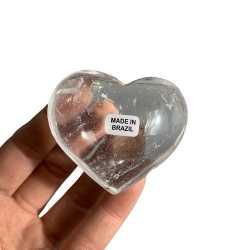 Kindred Crystal Collective — Clear Quartz Heart Brazil, medium polished transparent clear quartz heart with natural inclusions, size reference held in hand