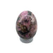 Cobaltian calcite egg close-up showing striking vivid pink colouring, a rare uplifting crystal for creativity, harmony and deep meditation