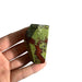 Kindred Crystal Collective — Dragon Blood Jasper Free Form, small polished green and red dragon blood jasper freeform, size reference with hand
