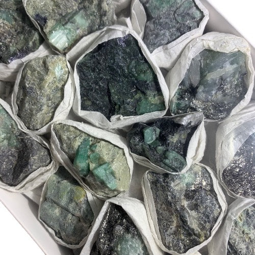 Kindred Crystal Collective — Emerald Rough Box, close-up detail of natural emerald rough showing hexagonal crystal structure and rich saturated green colouring