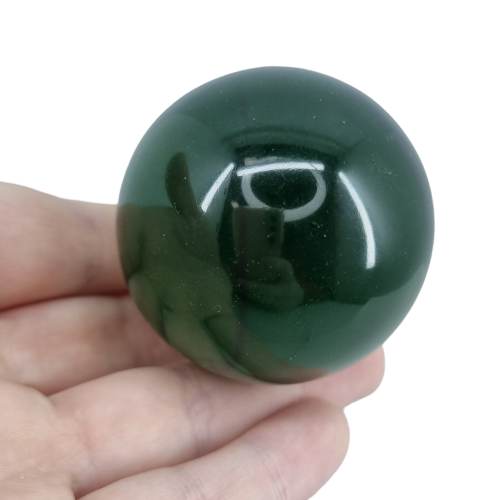 Kindred Crystal Collective — Green Obsidian Sphere, polished deep forest green glass sphere, size reference with hand