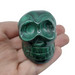 Malachite skull 180g showing striking green concentric banding, a powerful stone of transformation for third eye and heart chakra activation