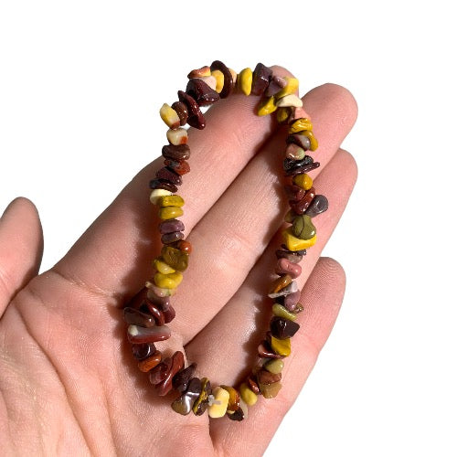 Kindred Crystal Collective — Mookaite Chip Bracelets (Pack of 5), irregular polished stone chips in earthy burgundy, mustard yellow, brown and cream tones.