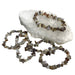 Kindred Crystal Collective — Natural Agate Chip Bracelet (Pack of 5), grey, cream and brown chip bracelets arranged around a white crystal cluster on a white background.