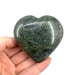 Nephrite jade heart close-up showing rich green tones and smooth waxy lustre, a timeless auspicious crystal for feng shui, protection and prosperity