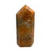 Kindred Crystal Collective — Orchid Calcite Generator, polished warm amber-orange orchid calcite generator point, angled view showing mottled surface detail