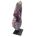 Kindred Crystal Collective — Polished Amethyst Cluster, side profile of tall sculptural amethyst cluster on black metal stand, white background