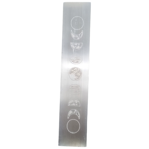 Selenite moon phase slab close-up showing translucent white glow and engraved moon phases, a healing crystal for spiritual clarity and peace