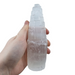 Selenite tower close-up showing luminous moonlike glow and natural striations, a healing crystal for mental calm and meditation