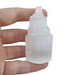 Small selenite tower showing luminous moonlike glow and natural striations, an affordable healing crystal for mental calm and meditation