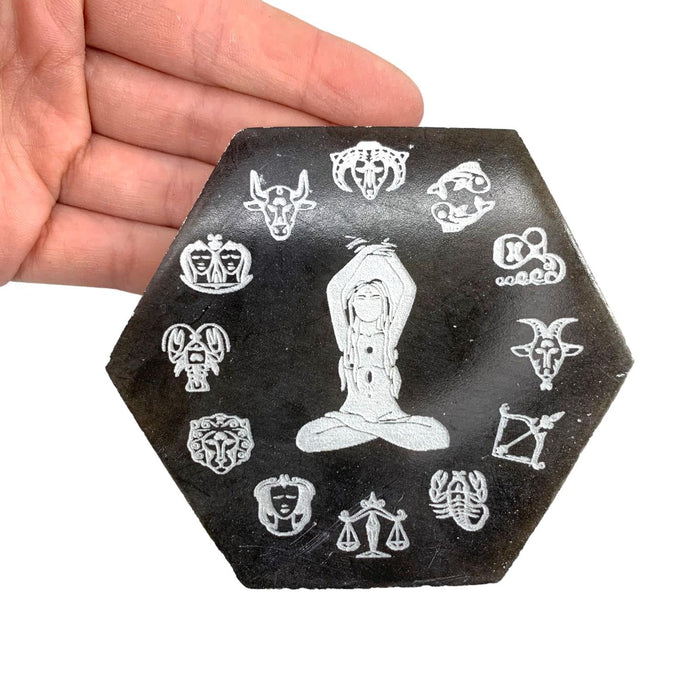 Selenite zodiac plate hexagon in black and white with engraved zodiac symbols, a crystal charging plate for cleansing and protection