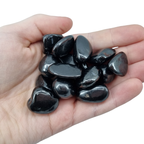 Kindred Crystal Collective — Shungite Tumbled 1.5–2.5cm, handful of polished deep black shungite tumbled stones held in open palm