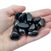 Kindred Crystal Collective — Shungite Tumbled 1.5–2.5cm, handful of polished deep black shungite tumbled stones held in open palm