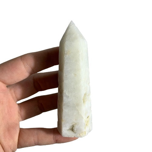 Kindred Crystal Collective — Sphalerite White Generator, polished creamy white sphalerite generator point with matte granular surface, size reference held in hand, variant 1