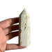 Kindred Crystal Collective — Sphalerite White Generator, polished off-white sphalerite generator point with natural inclusions and textured surface, size reference held in hand, variant 2