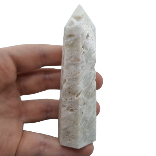 Kindred Crystal Collective — Sphalerite White Generator, polished pale ivory sphalerite generator point with granular surface detail, size reference held in hand, variant 3
