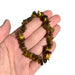 Kindred Crystal Collective — Tiger Eye Gold Chip Bracelets (Pack of 5), polished golden-brown stone chips with rich banding and a silky reflective sheen.