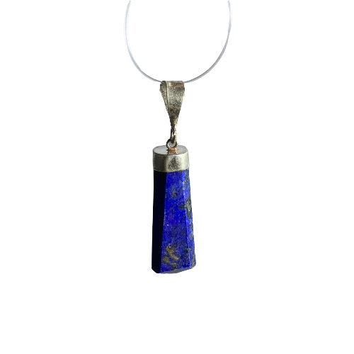 Kindred Crystal Collective — Lapis Lazuli Sterling Silver Pendant, elongated angular deep blue stone with mottled inclusions, silver cap and bail on a white background.