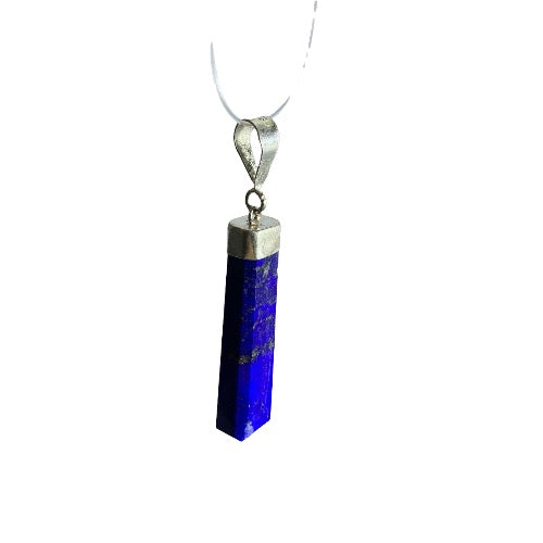 Kindred Crystal Collective — Lapis Lazuli Sterling Silver Pendant, elongated angular deep blue stone with mottled inclusions, silver cap and bail on a white background.